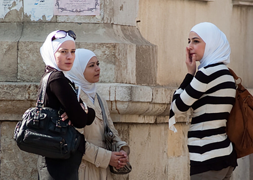 Damaskus and Aleppo, women talking in a street corner